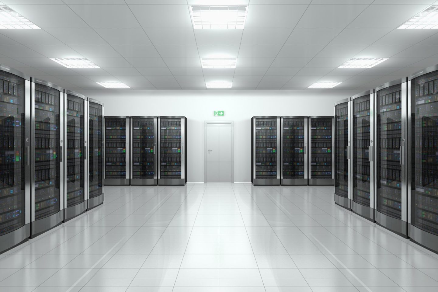 A modern server room with rows of server racks, bright lighting, and a central door at the back.