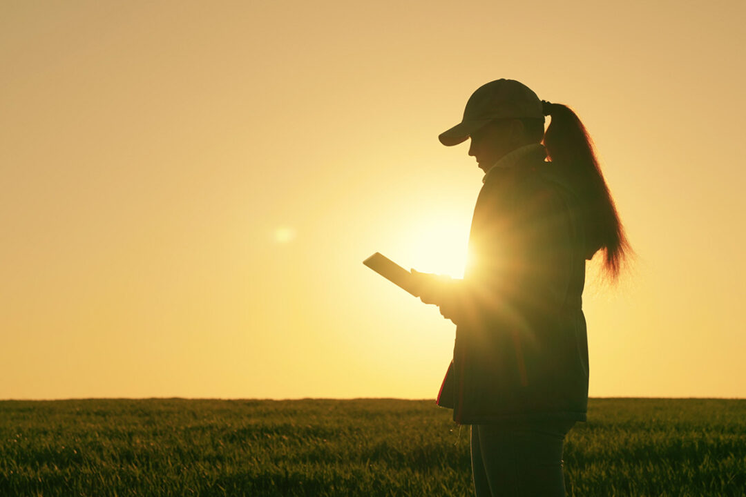 Woman using iPad in a field