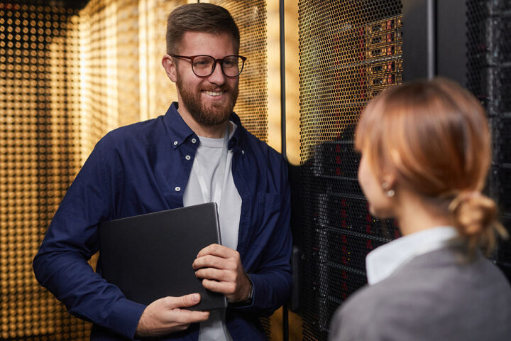 smiling-it-professional-holding-laptop-while-talki-2025-10-06-19-51-17-utc (1200×800)